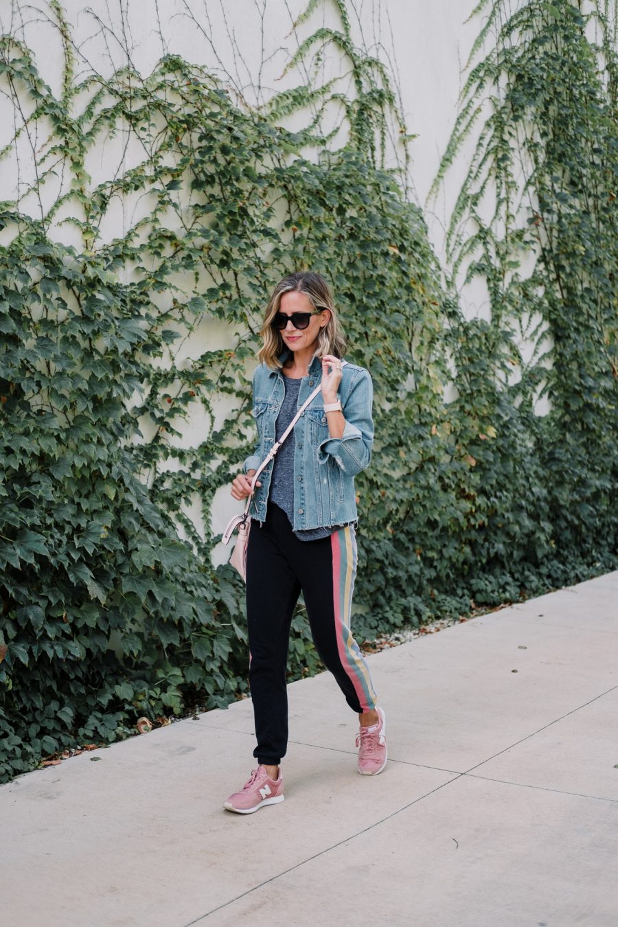 Wildfox sweatpants, tee, denim jacket, New Balance sneakers, cross body bag