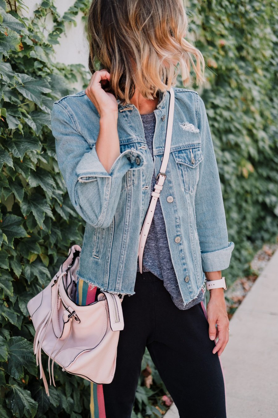 Wildfox sweatpants, tee, denim jacket, New Balance sneakers, cross body bag