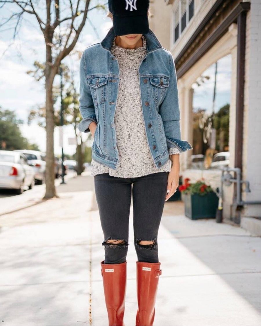 NY baseball cap, denim jacket, sweater, black denim, and Hunter boots