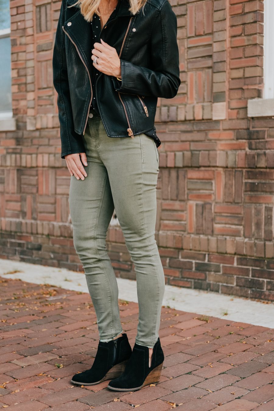 Budget friendly style: olive pants, polka dot blouse, moto jacket, booties, and sunglasses