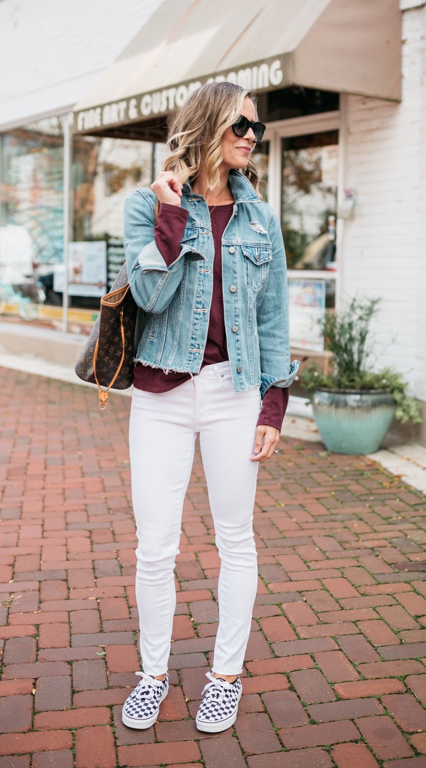 White denim, long sleeve tee, denim jacket, Vans sneakers, and Louis Vuitton bag