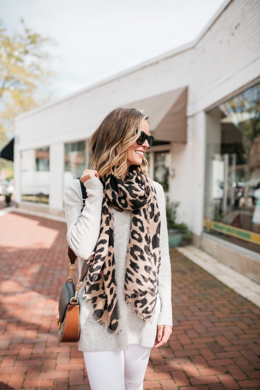 White denim for fall, grey sweater, leopard scarf, cross body bag, booties