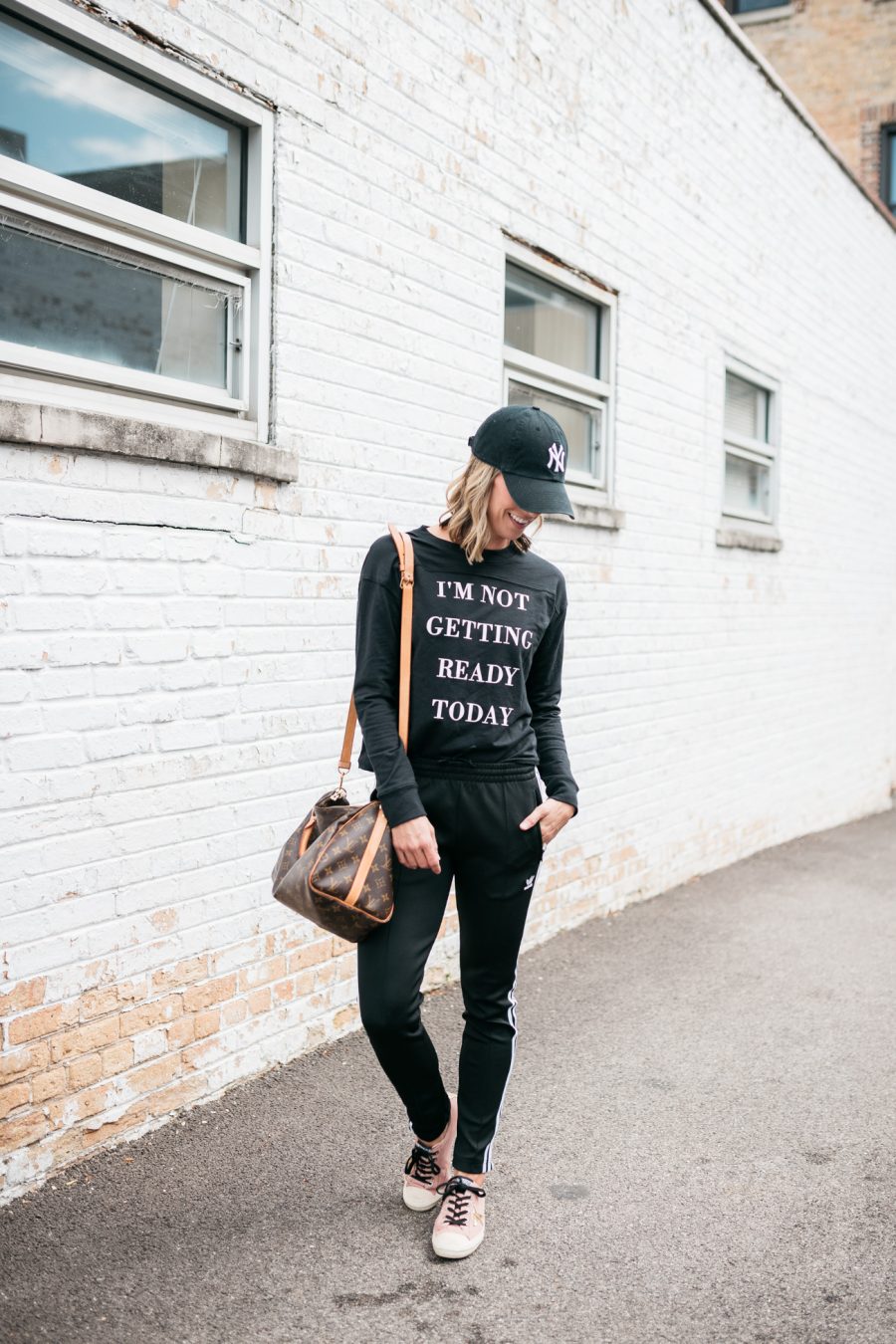 Pullover, Adidas track pants, Louis Vuitton bag, Nike hat, Golden Goose deluxe brand sneakers