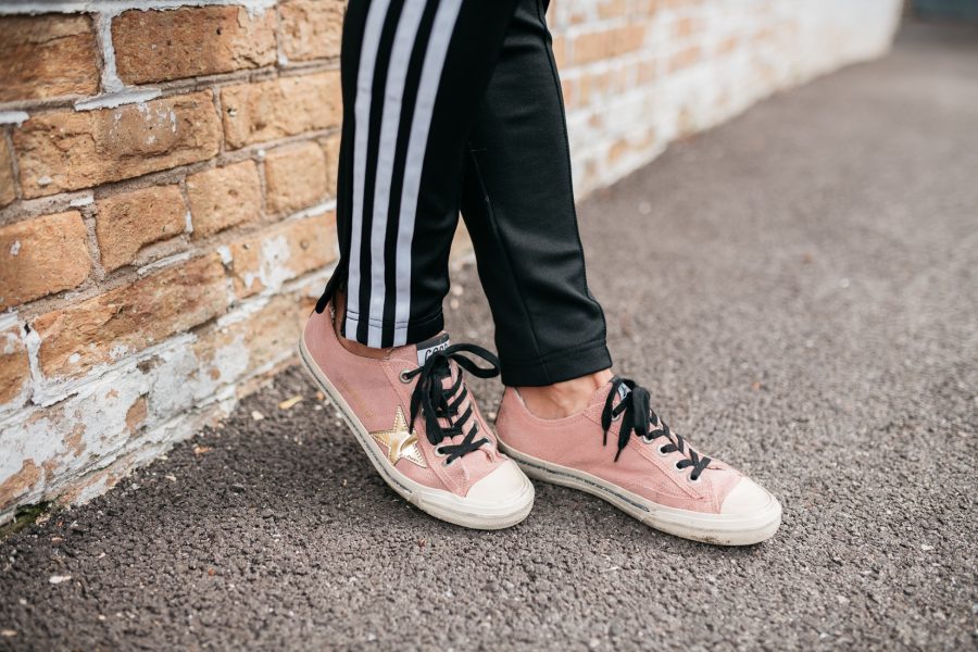 Adidas track pants and Golden Goose Deluxe brand sneakers