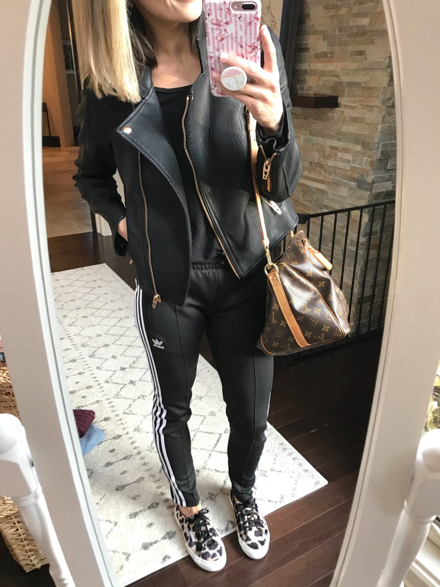 Black moto jacket and Adidas track pants