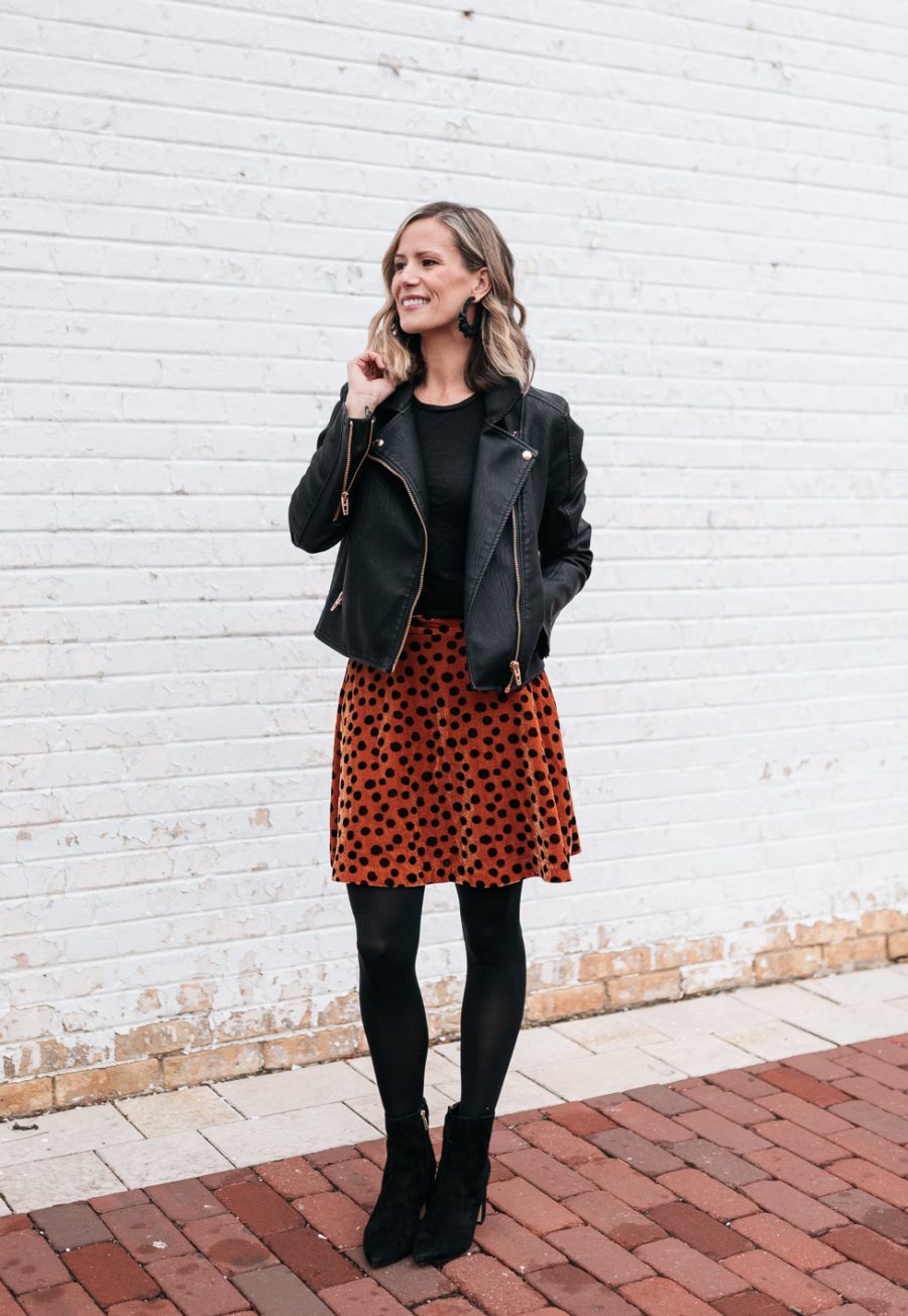 Cozy holiday party outfit: leopard skirt, tights, booties, and moto jacket