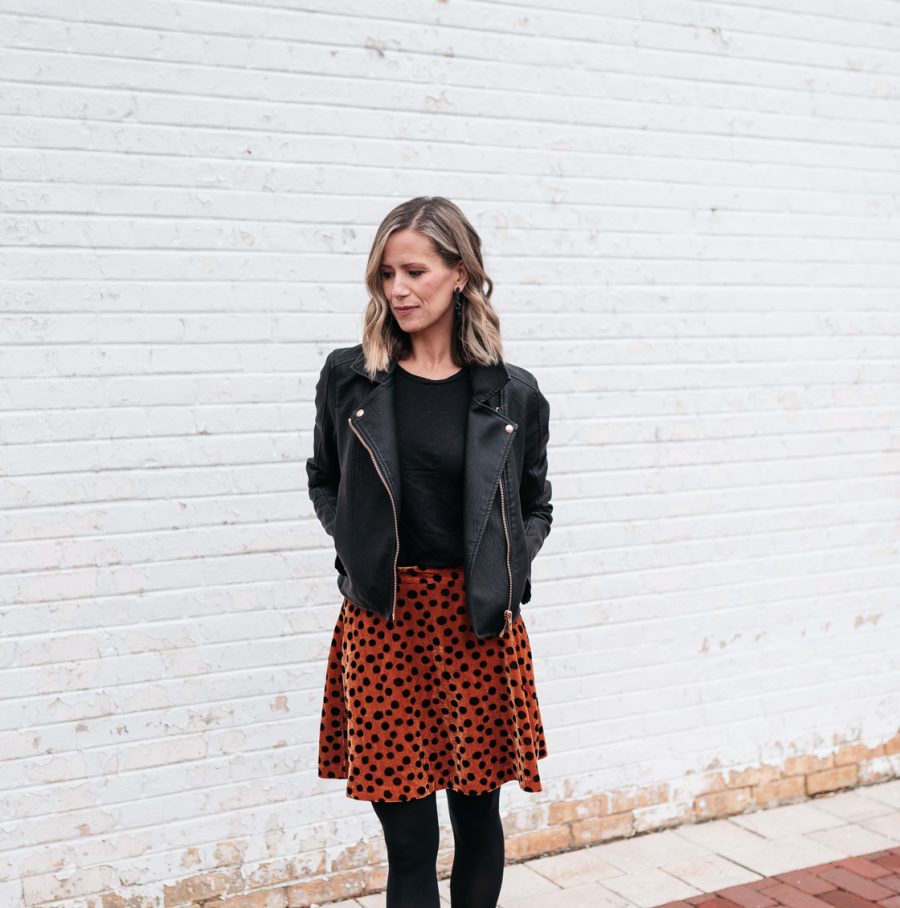 Cozy holiday party outfit: leopard skirt, tights, booties, and moto jacket