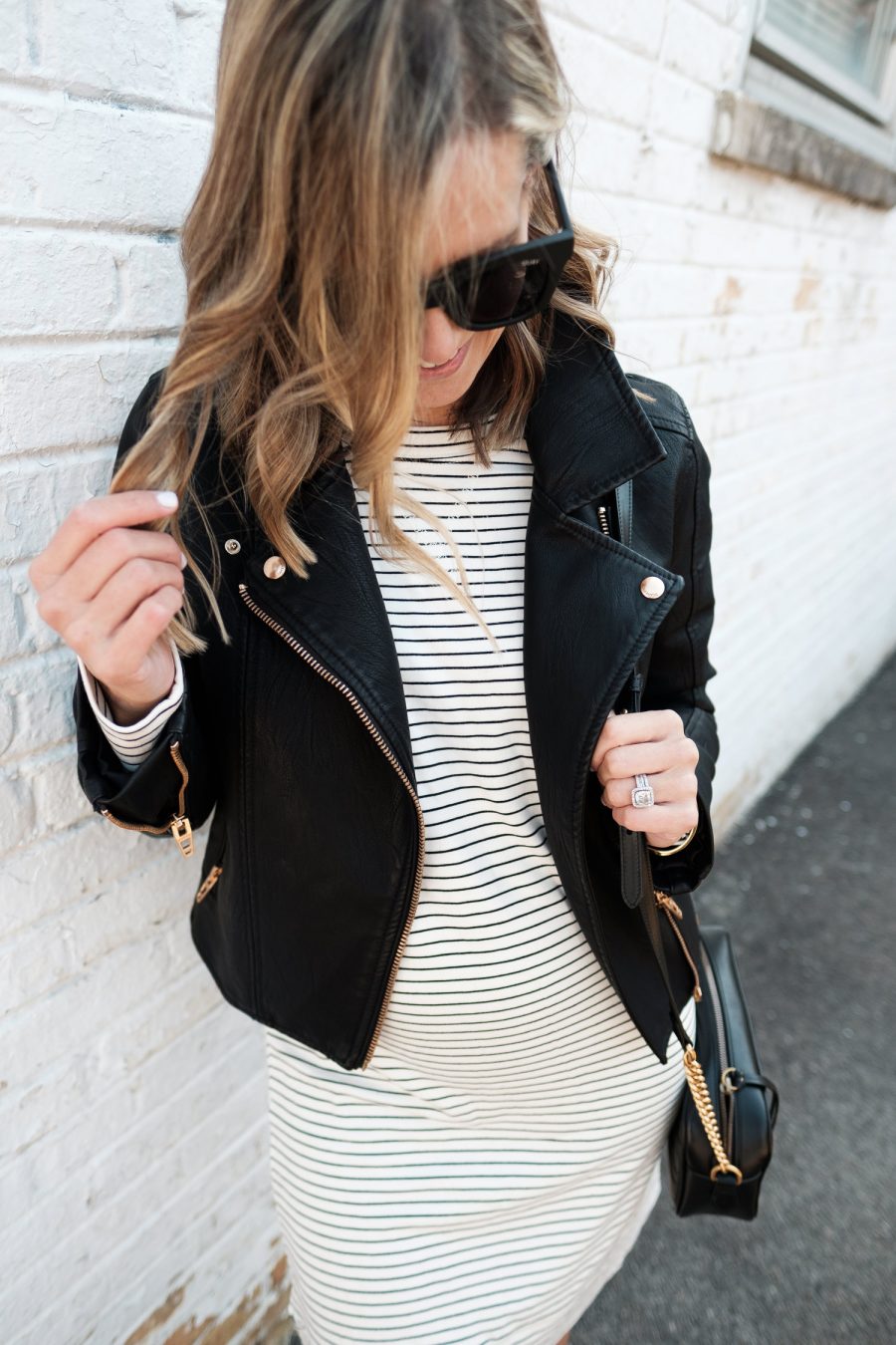 $30 sweatshirt dress with moto jacket, crossbody bag, and sneakers