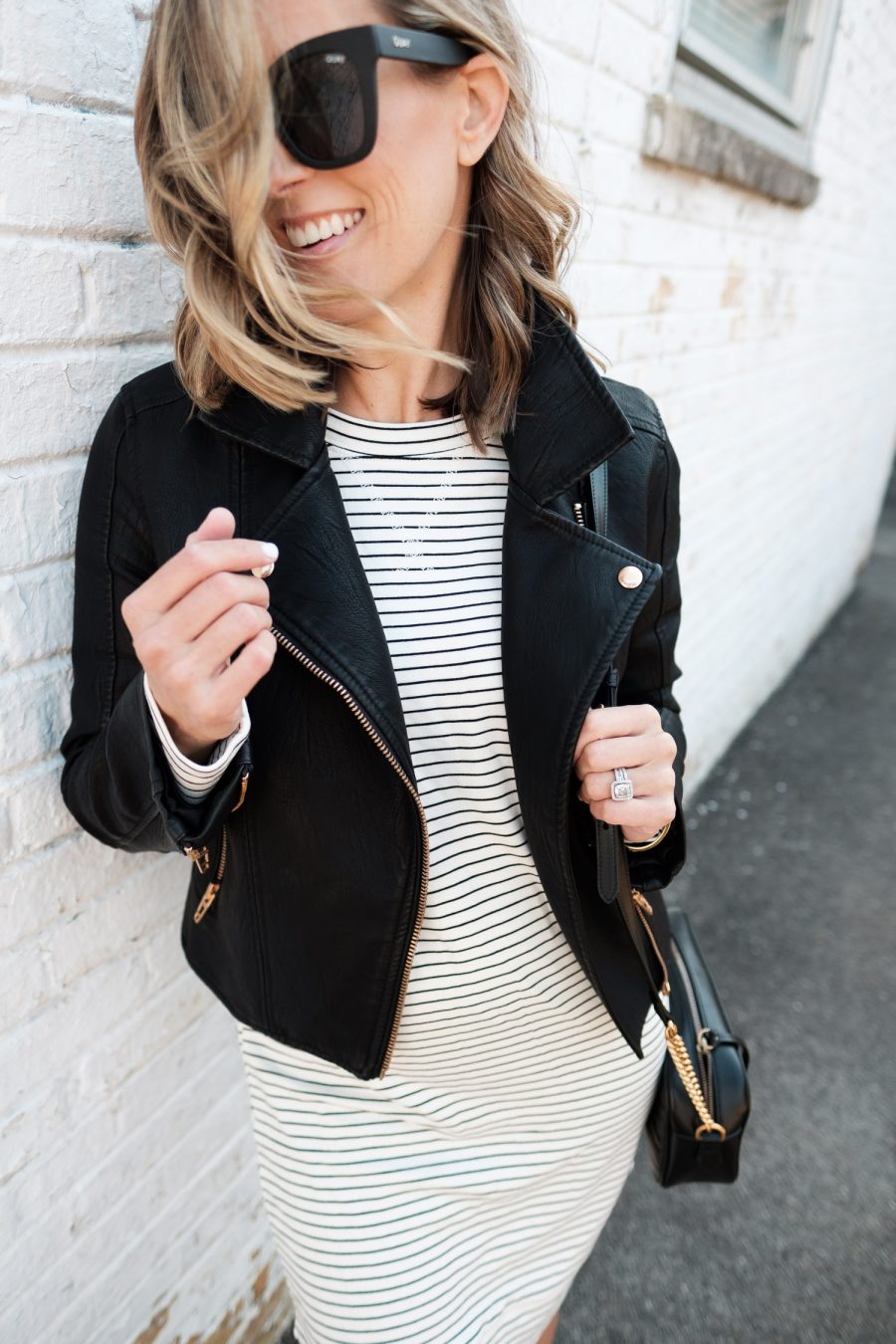 $30 sweatshirt dress with moto jacket, crossbody bag, and sneakers
