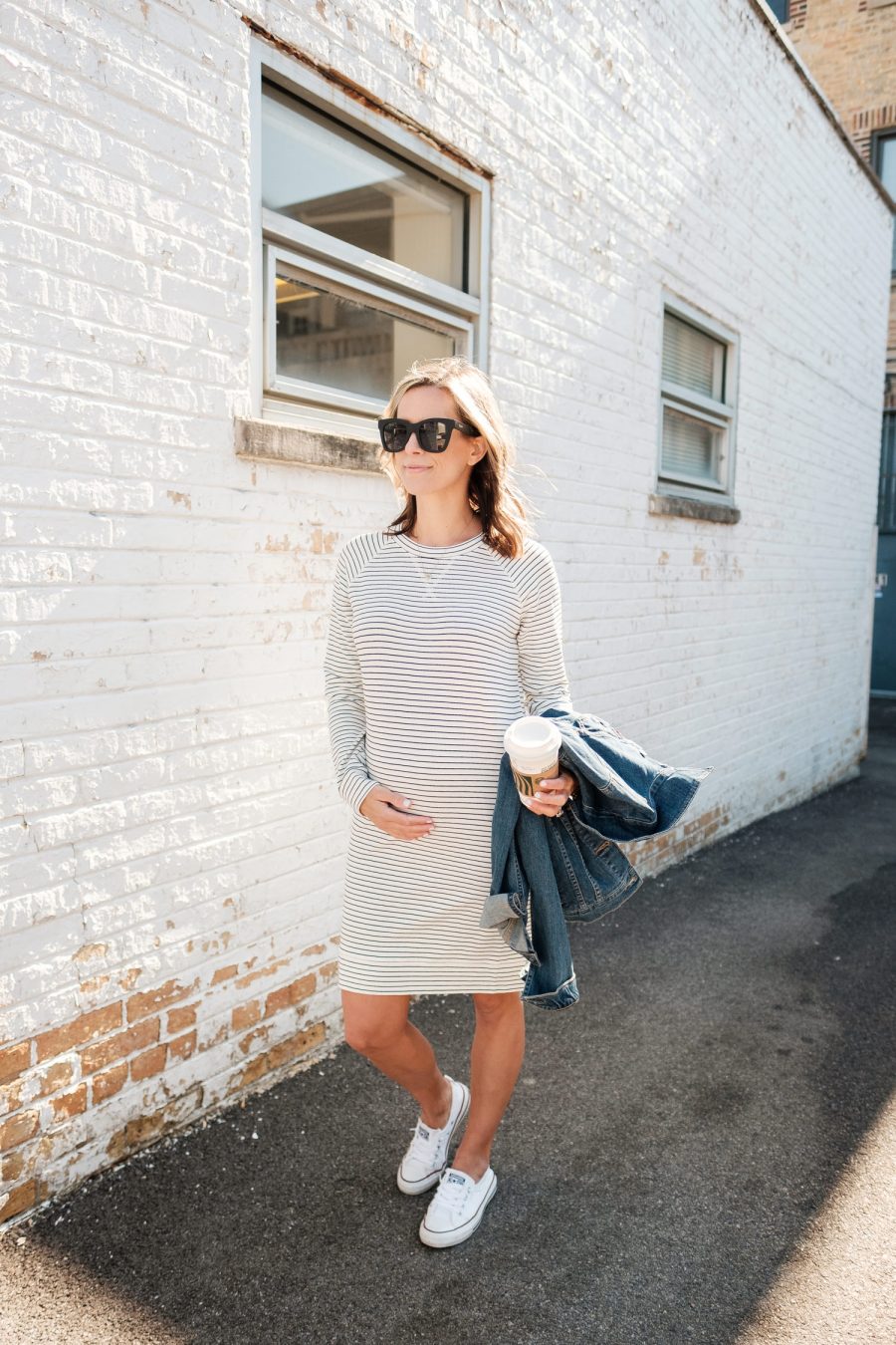 $30 sweatshirt dress with a trench coat, rain boots, and crossbody bag