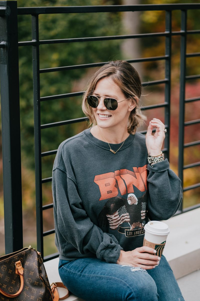 Postpartum casual outfit: sweatshirt, jeans, and sneakers