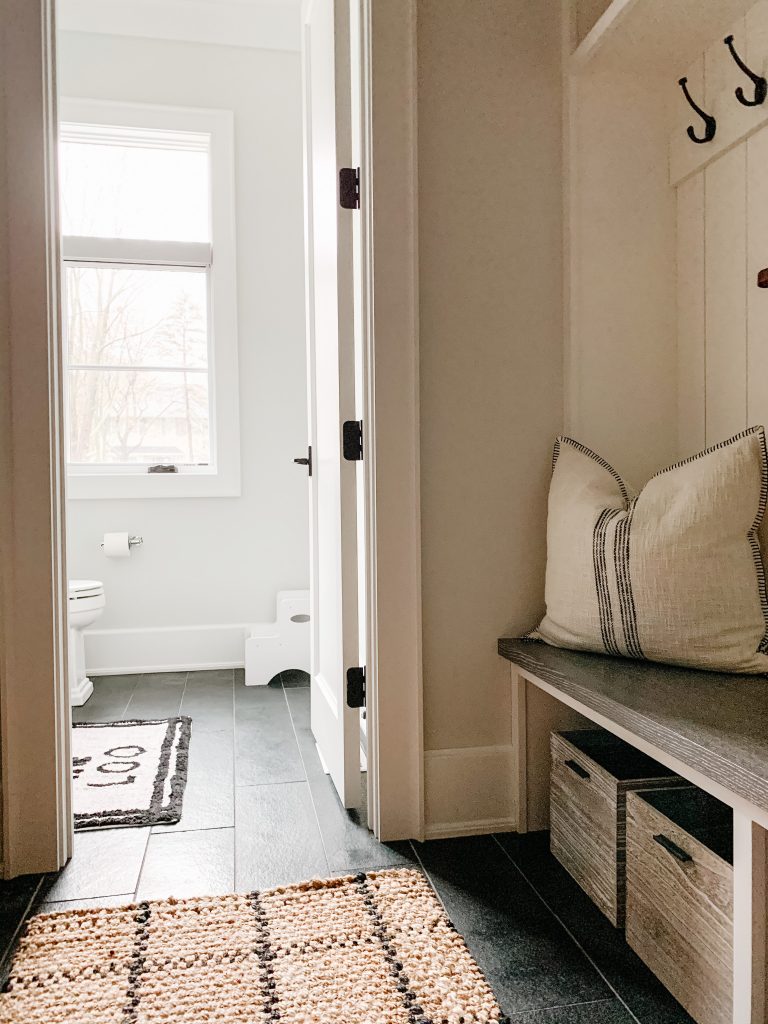 I'm sharing a glimpse into our mudroom and my favorite baskets, hooks, and bins to keep the space organized and give easy access to the kids.