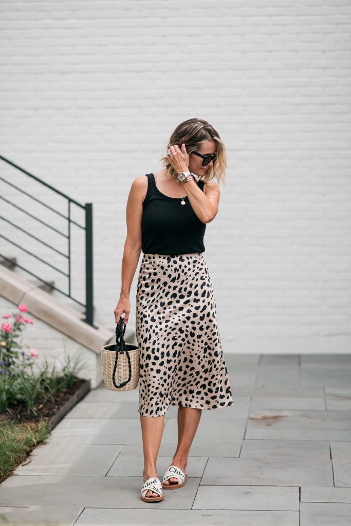 I'm sharing a classic leopard slip skirt and how I'm transitioning it from summer to fall with a classic tank, denim jacket, and accessories.