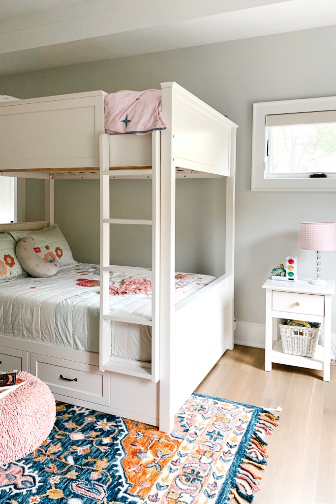 Transition to a big girl bedroom with bunkbeds, vibrant pops of color, and a cozy reading area.