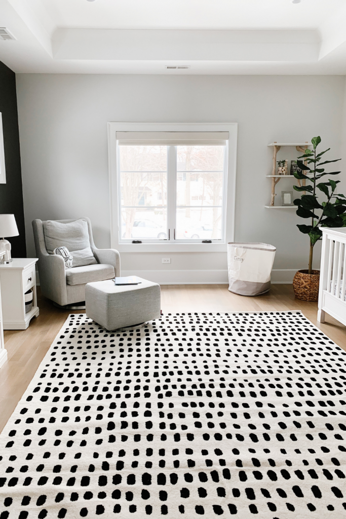 Revealing Baby Gray's nursery featuring a printed accent wall to pop against the minimalistic and sleek furniture and decor.