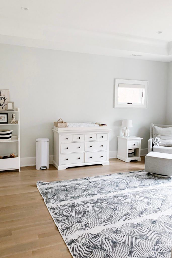 Revealing Baby Gray's nursery featuring a printed accent wall to pop against the minimalistic and sleek furniture and decor.