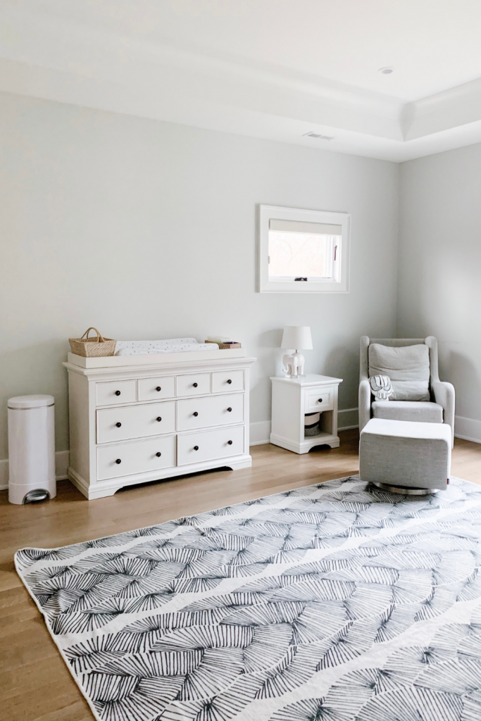 Revealing Baby Gray's nursery featuring a printed accent wall to pop against the minimalistic and sleek furniture and decor.