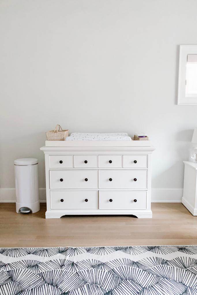 Revealing Baby Gray's nursery featuring a printed accent wall to pop against the minimalistic and sleek furniture and decor.