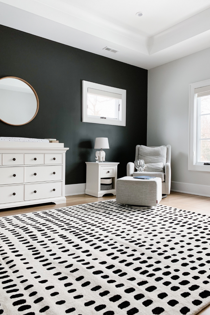 Revealing Baby Gray's nursery featuring a printed accent wall to pop against the minimalistic and sleek furniture and decor.