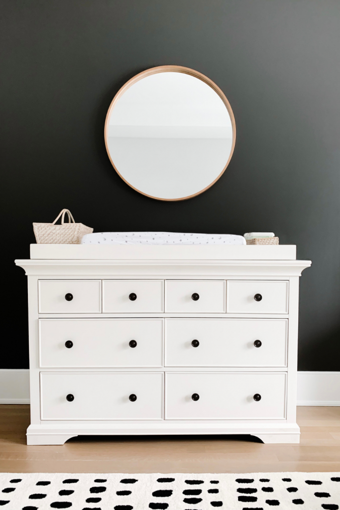Revealing Baby Gray's nursery featuring a printed accent wall to pop against the minimalistic and sleek furniture and decor.