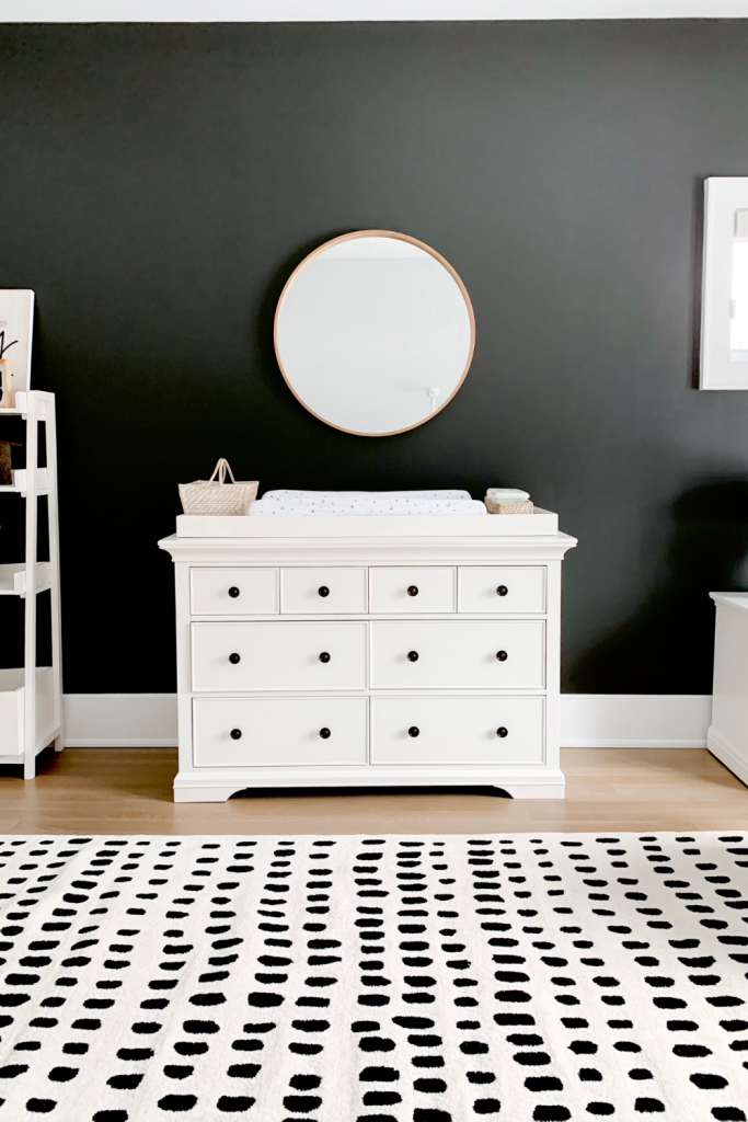 Revealing Baby Gray's nursery featuring a printed accent wall to pop against the minimalistic and sleek furniture and decor.