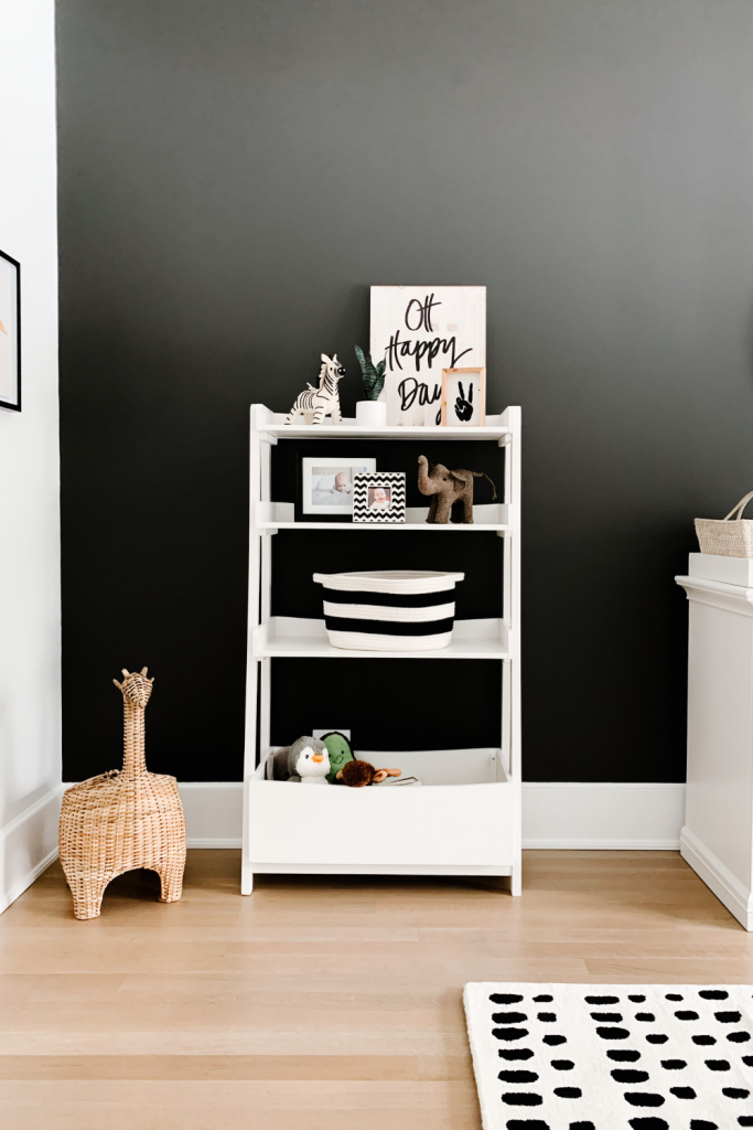 Revealing Baby Gray's nursery featuring a printed accent wall to pop against the minimalistic and sleek furniture and decor.
