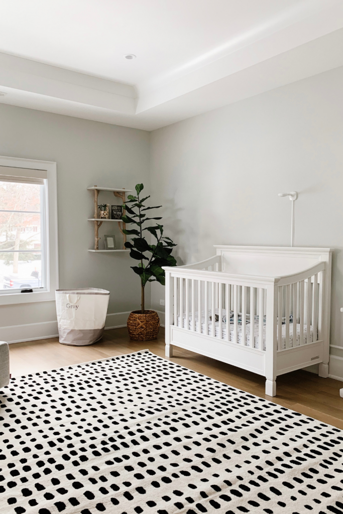 Revealing Baby Gray's nursery featuring a printed accent wall to pop against the minimalistic and sleek furniture and decor.