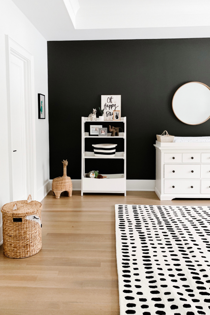 Revealing Baby Gray's nursery featuring a printed accent wall to pop against the minimalistic and sleek furniture and decor.