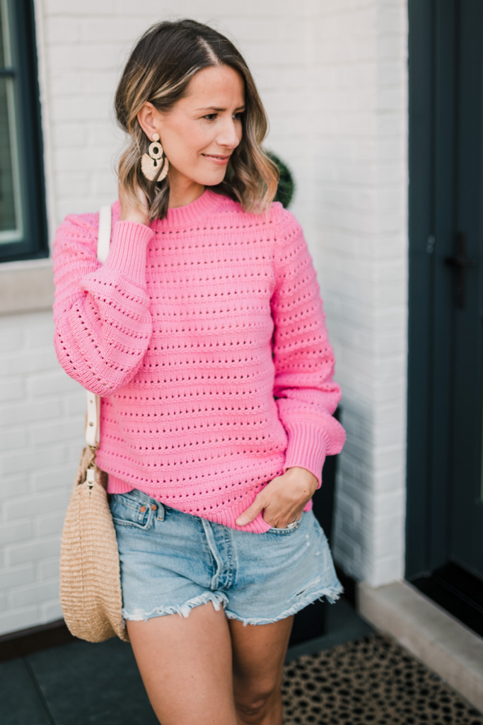Sweater, denim shorts, round straw tote, sandals