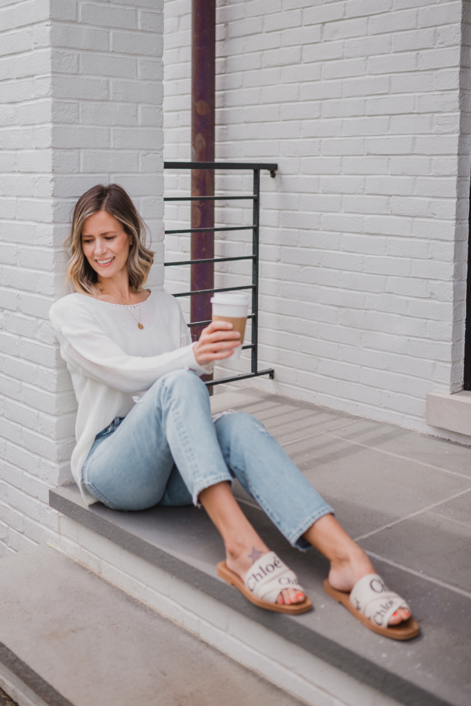 Spring outfit: white sweater, jeans, necklace, and sandals
