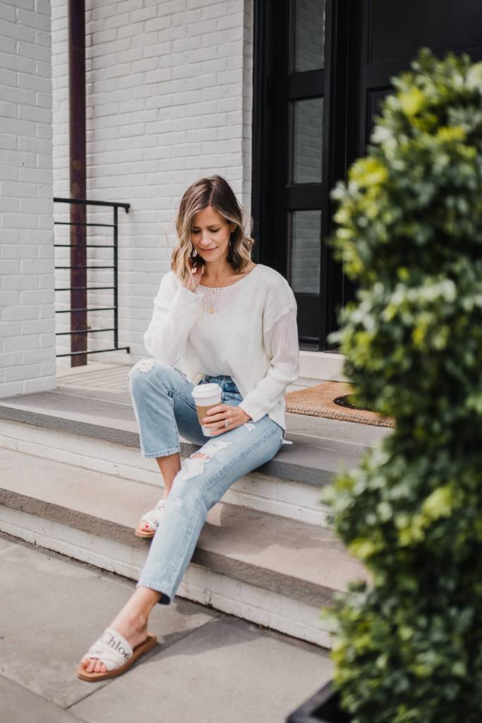 Spring outfit: white sweater, jeans, necklace, and sandals