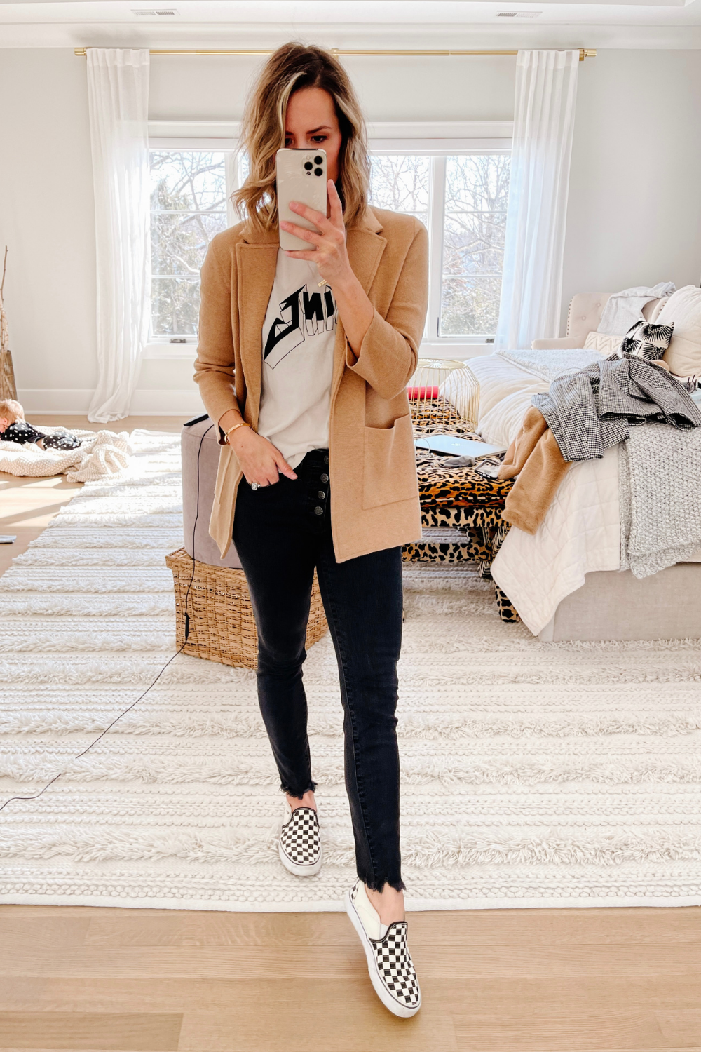 Suzanne wearing an Anne Bing tank, sweater blazer, black skinny jeans and Vans