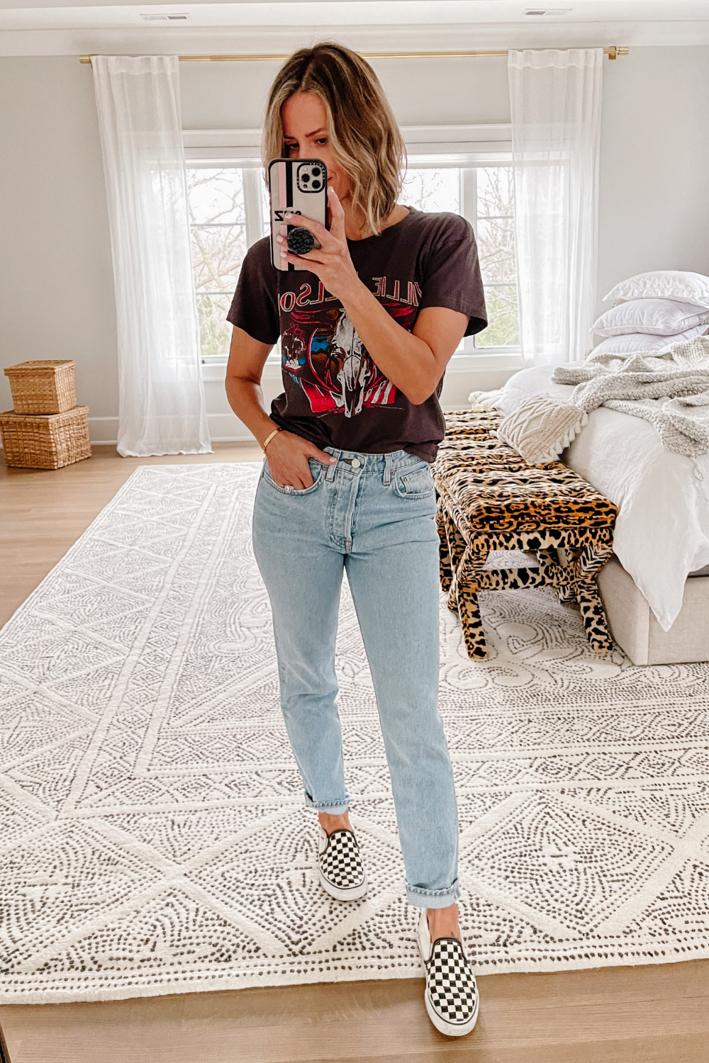 Suzanne wearing a Willie Nelson tee, denim jeans, and Vans