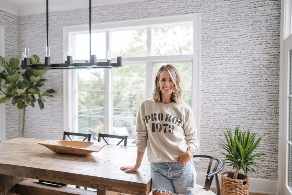 Suzanne wearing a "Pro Roe" sweatshirt in the kitchen nook