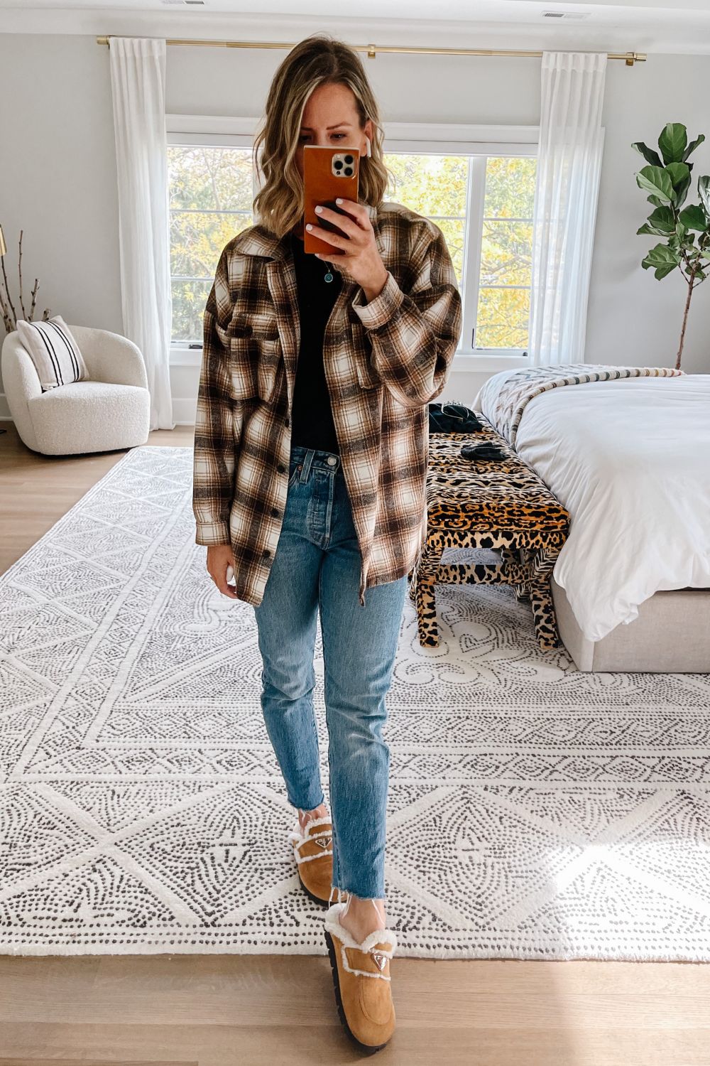 Suzanne wearing a fleece shacket, denim jeans, and Prada clogs