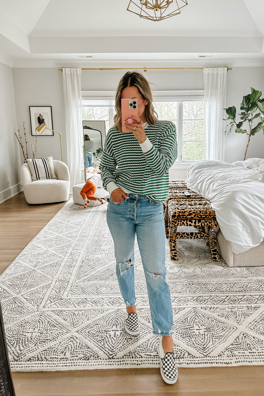 Suzanne wearing a sweater and jeans