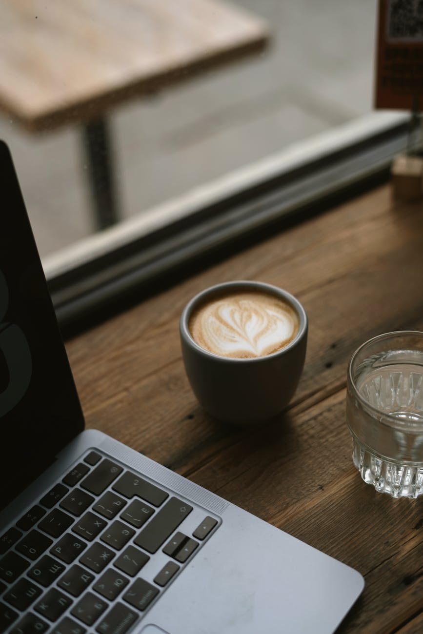 modern laptop and coffee on cafe table